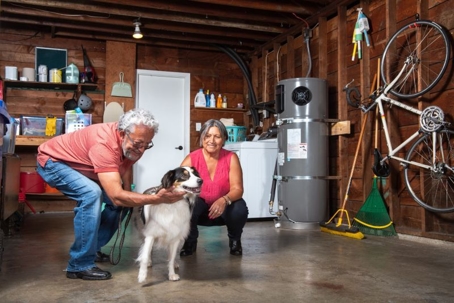 Family in garage with tank water heater.